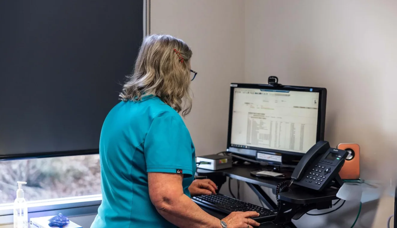 A practice nurse at the treatment room desk