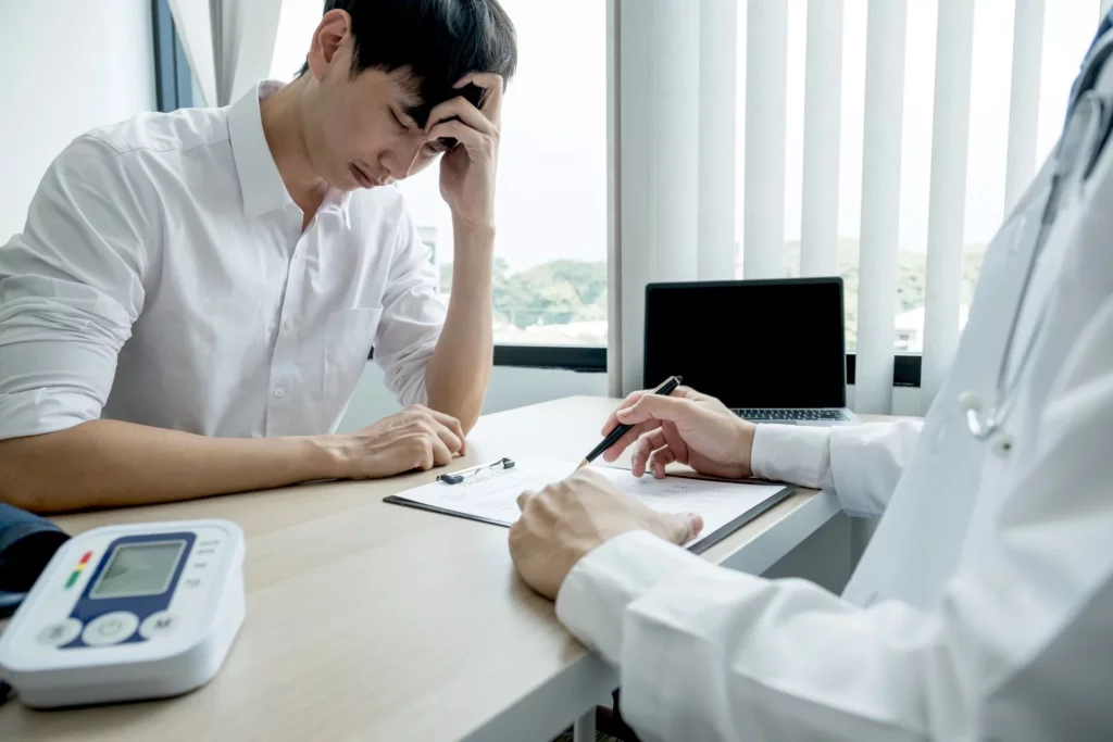 A doctor pointing at a report and explaining it to a patient