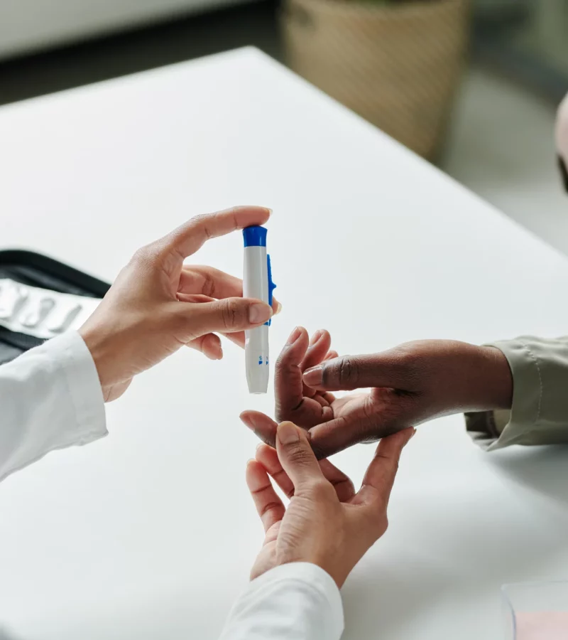 A patient's blood glucose level being checked