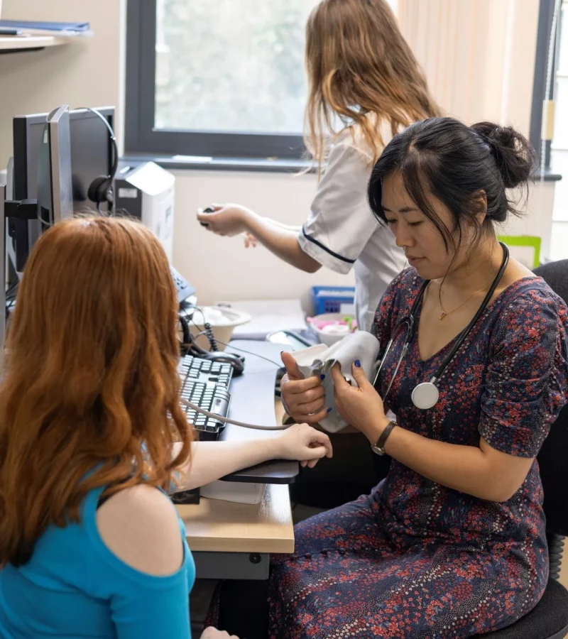 A health professional taking a patient’s blood pressure