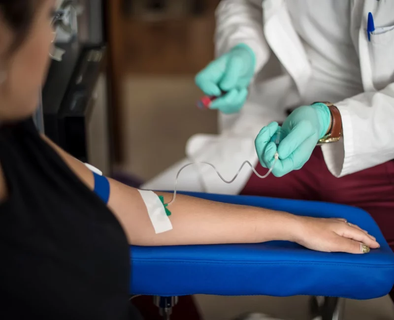 A nurse taking a blood sample for a medical examination