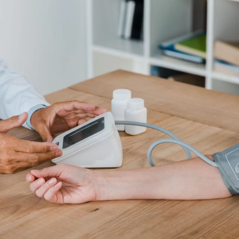 A doctor measuring a patient’s blood pressure