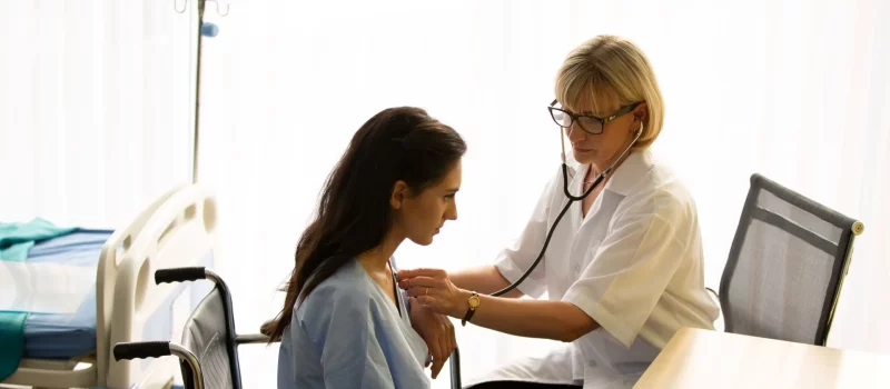 A doctor advising a patient in a consulting room